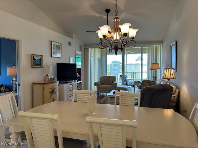 dining area with vaulted ceiling and an inviting chandelier