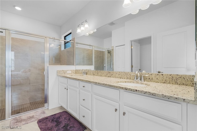 bathroom with vanity, tile patterned floors, and walk in shower