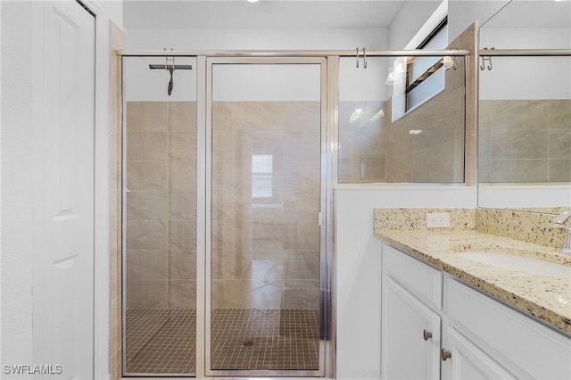 bathroom featuring vanity and an enclosed shower