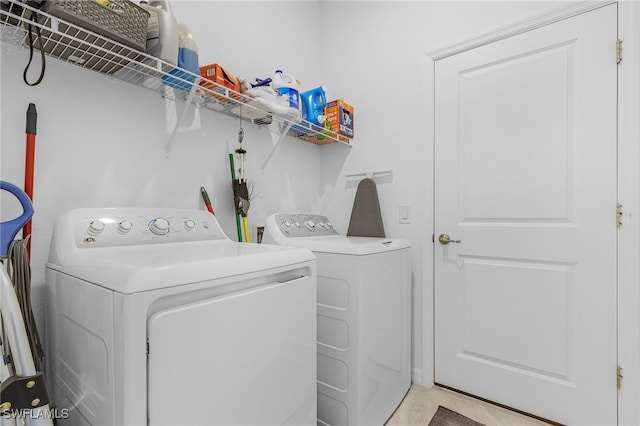 clothes washing area featuring washer and dryer