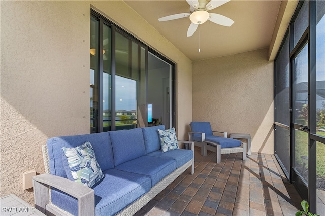 sunroom featuring ceiling fan