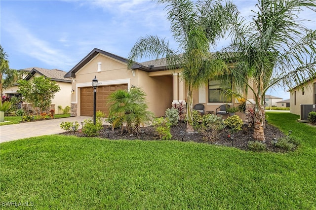 view of front facade featuring a front yard, central AC, and a garage