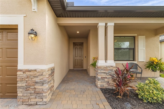 view of exterior entry featuring a garage