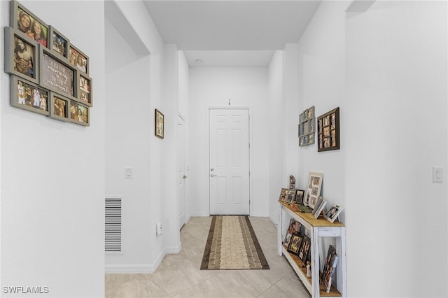 hall with light tile patterned floors