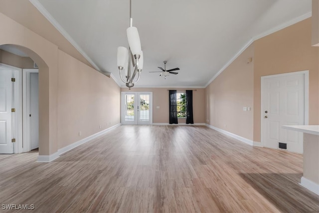 interior space featuring ceiling fan, french doors, crown molding, lofted ceiling, and light wood-type flooring