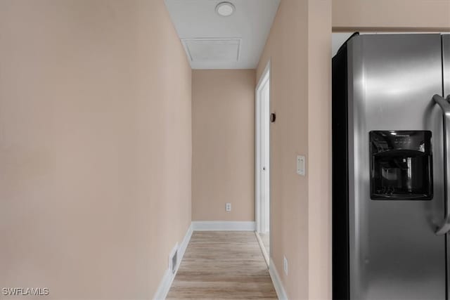 corridor with light hardwood / wood-style flooring