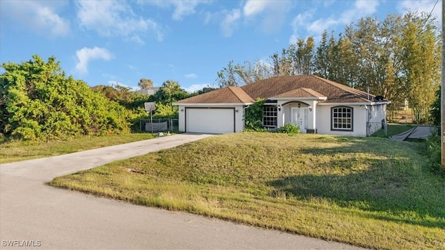 ranch-style home with a front yard and a garage