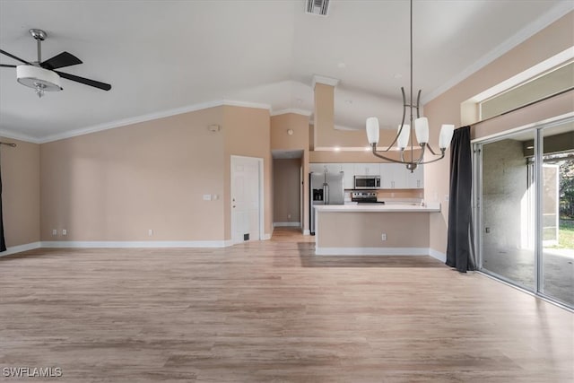 kitchen featuring stainless steel appliances, white cabinetry, hanging light fixtures, and light hardwood / wood-style flooring