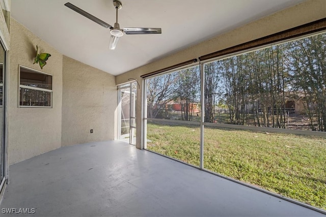 unfurnished sunroom with ceiling fan and lofted ceiling