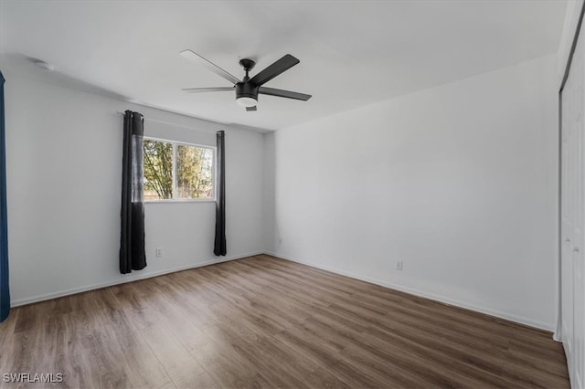 spare room with hardwood / wood-style flooring and ceiling fan