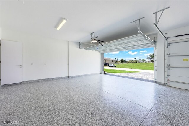 garage with a garage door opener and a carport