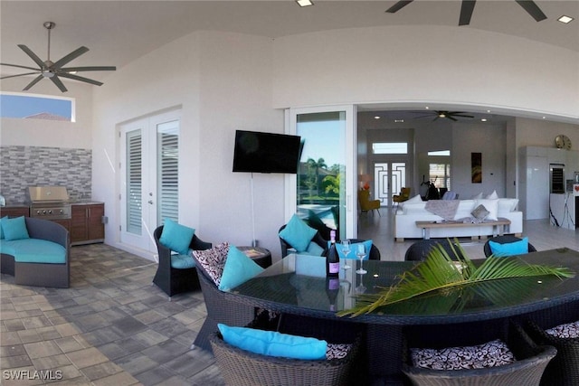 view of patio with french doors, ceiling fan, area for grilling, and grilling area