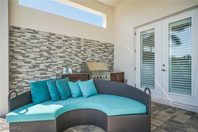 view of patio featuring french doors, an outdoor living space, area for grilling, and a grill