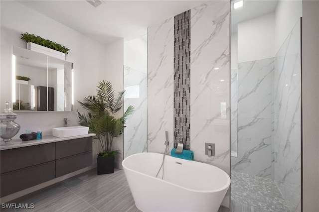 bathroom featuring vanity and separate shower and tub