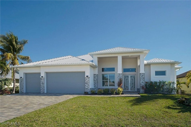 view of front of house featuring a front yard and a garage