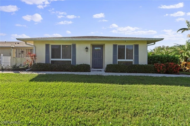 ranch-style house featuring a front lawn