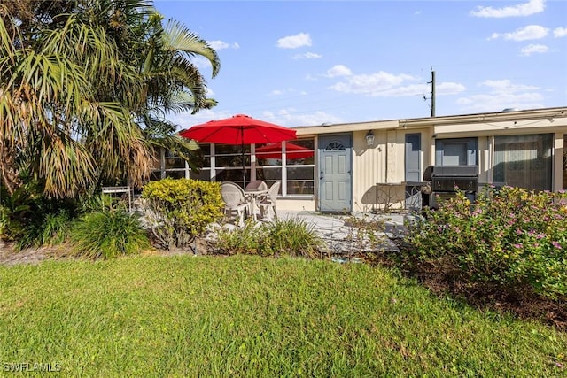 rear view of house featuring a yard