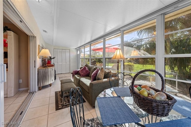 39 Glades Blvd Unit 1, Naples, FL 34112 - sunroom featuring tile patterned floors, an outdoor hangout area, and expansive windows