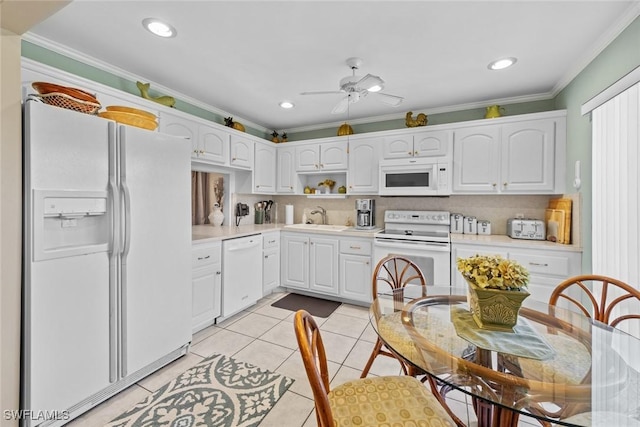 39 Glades Blvd Unit 1, Naples, FL 34112 - kitchen with white appliances, ornamental molding, a sink, light countertops, and white cabinetry