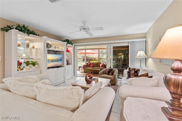 tiled living room featuring ceiling fan