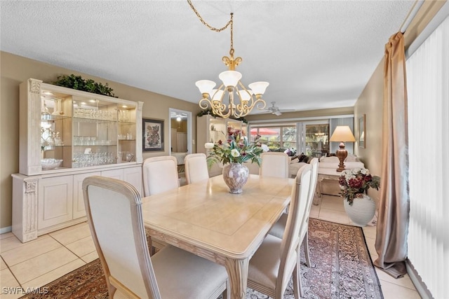 39 Glades Blvd Unit 1, Naples, FL 34112 - dining room featuring a chandelier, light tile patterned floors, and a textured ceiling
