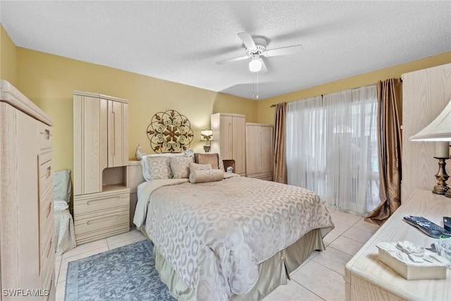 tiled bedroom featuring a textured ceiling, a closet, and ceiling fan