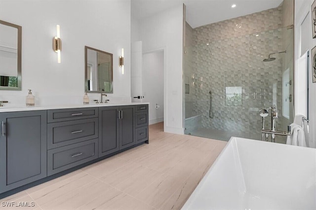 bathroom featuring vanity, tiled shower, and tile patterned floors