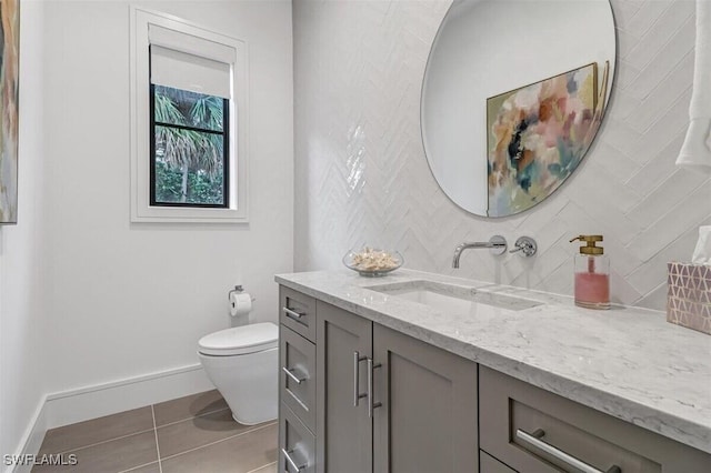 bathroom with vanity, toilet, and tile patterned floors