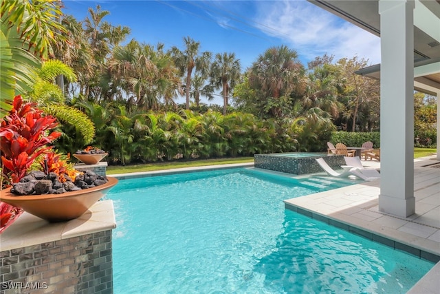 view of swimming pool with an in ground hot tub