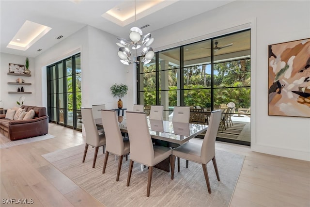 dining area featuring a notable chandelier and light wood-type flooring