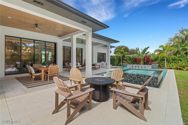 view of patio featuring an in ground hot tub and ceiling fan