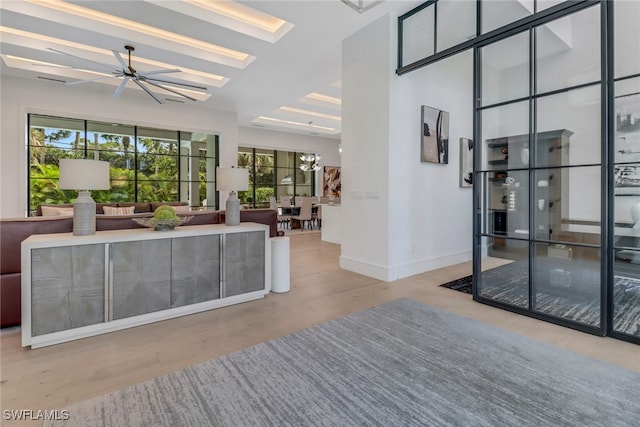 living room with an inviting chandelier and light wood-type flooring