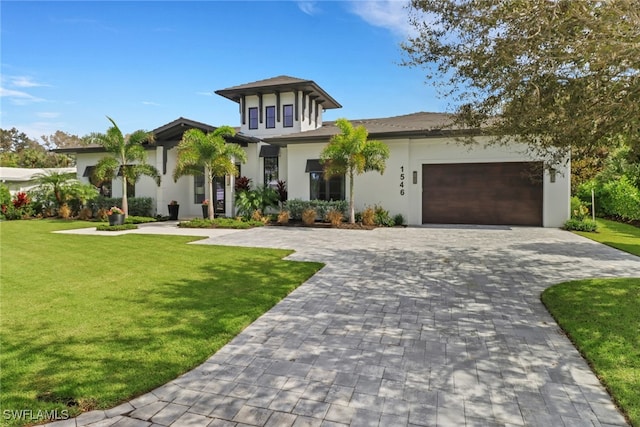 view of front of house featuring a front yard and a garage