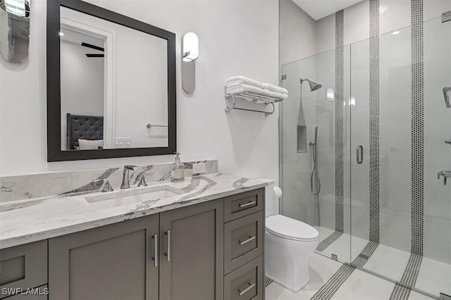 bathroom featuring vanity, toilet, and walk in shower