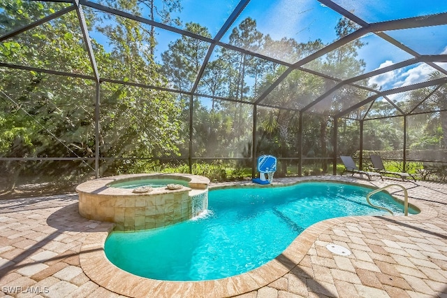 view of pool featuring an in ground hot tub, a patio area, and glass enclosure