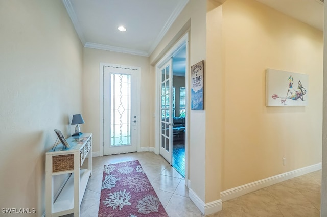 entryway featuring crown molding and light tile patterned flooring