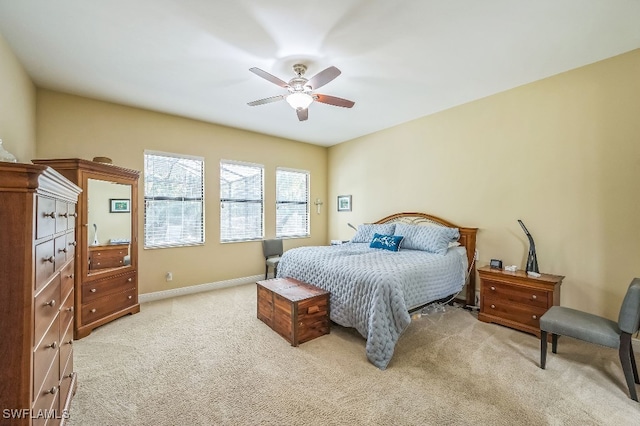 bedroom with light carpet and ceiling fan