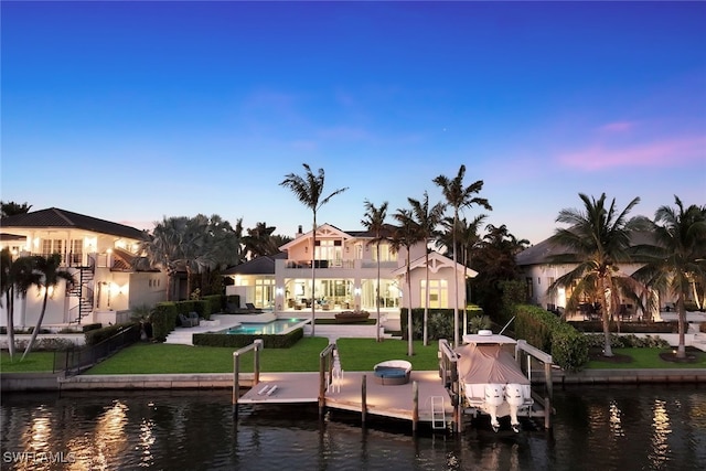 view of dock with boat lift, a water view, stairway, an outdoor pool, and a patio area