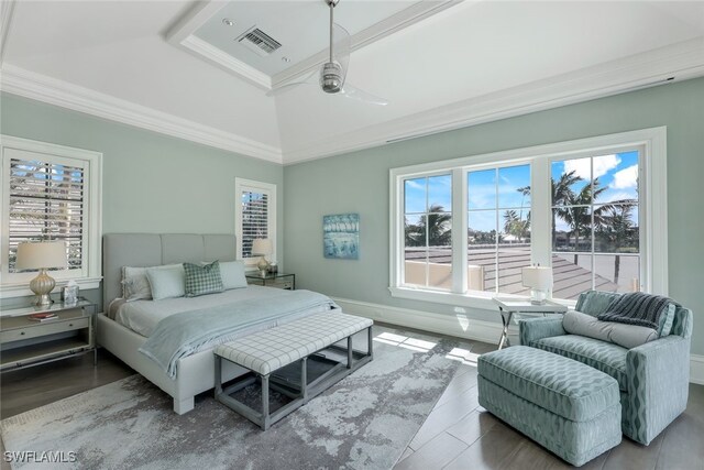 bedroom with vaulted ceiling, ornamental molding, and wood-type flooring