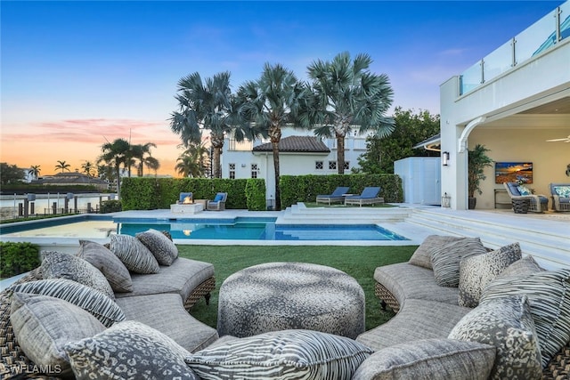 view of swimming pool featuring an outdoor hangout area, a patio area, fence, and a fenced in pool