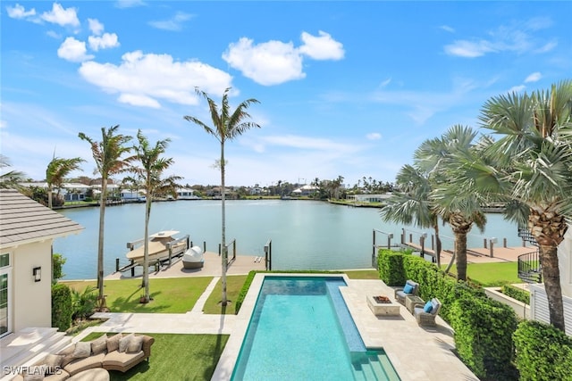 view of pool with an outdoor fire pit, a water view, a yard, and a boat dock