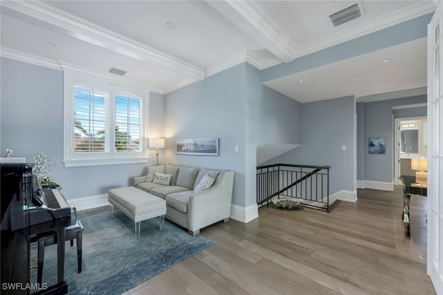 living room featuring hardwood / wood-style floors, ornamental molding, and beamed ceiling