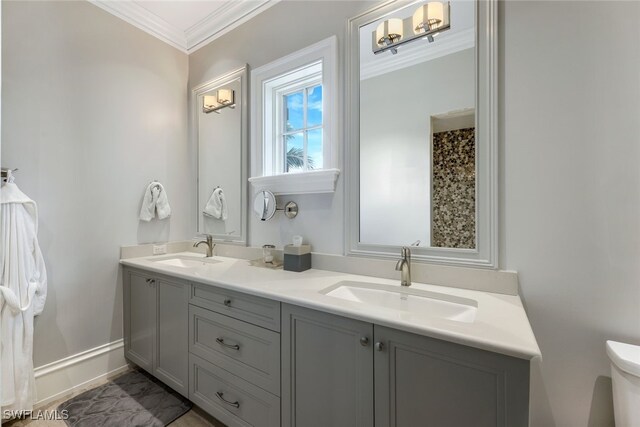 bathroom with ornamental molding, toilet, and vanity