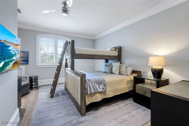 bedroom with crown molding, ceiling fan, and light wood-type flooring