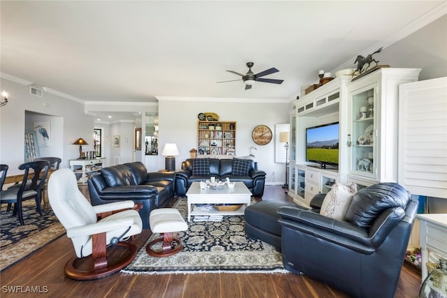 living room with crown molding, dark wood-type flooring, and ceiling fan