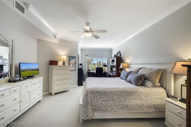 carpeted bedroom with ornamental molding and ceiling fan