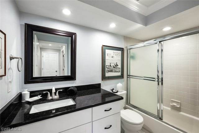 full bathroom featuring vanity, crown molding, shower / bath combination with glass door, and toilet