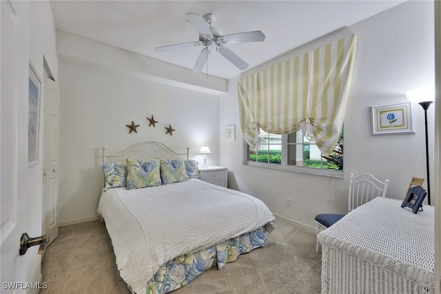 bedroom with light carpet and ceiling fan