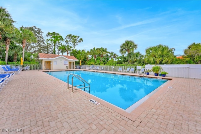 view of pool with an outdoor structure and a patio