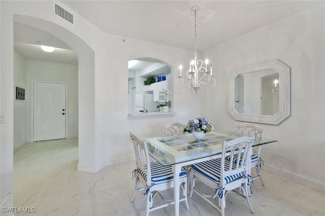 dining space featuring a notable chandelier